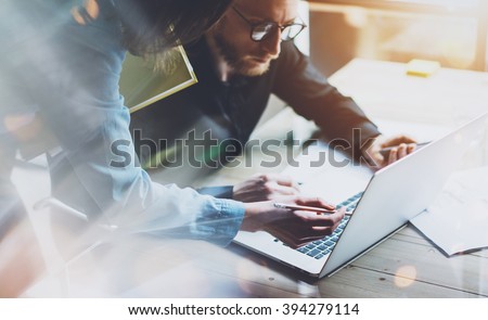 Team work process. Photo young business crew working with new startup project laptop. Project managers meeting. Analyze plans, papers. Blurred background, film effect Royalty-Free Stock Photo #394279114