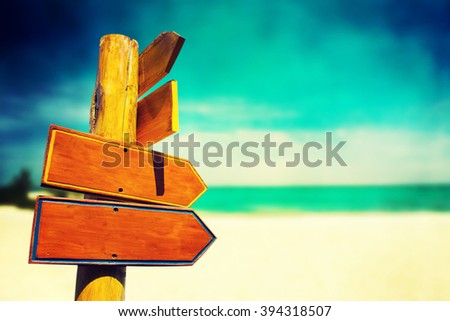 wood sign on beach