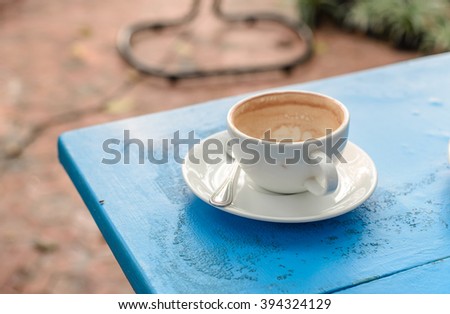 White cup coffee on blue wooden table