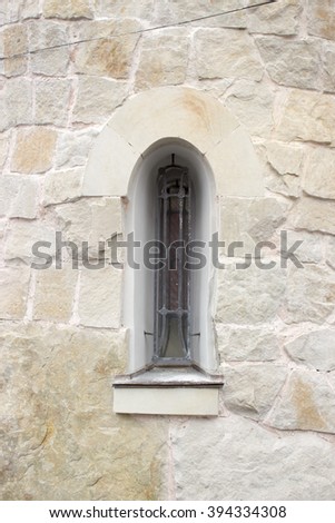 Gothic window in stone wall
