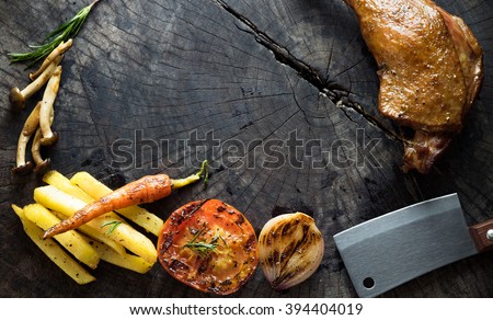 Grilled duck with side dish on wood, top view 