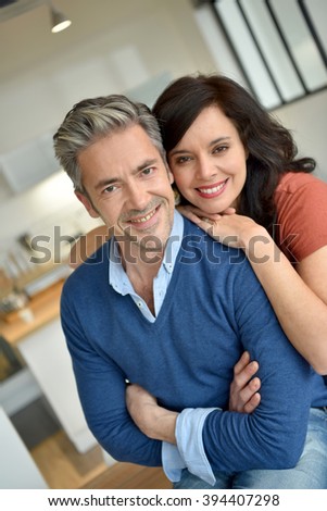 Portrait of middle-aged couple enjoying new home