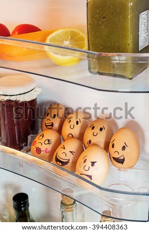 Funny egg faces in a fridge door.