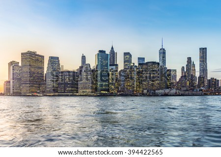 Manhattan Downtown urban view with Brooklyn bridge in sunset Royalty-Free Stock Photo #394422565