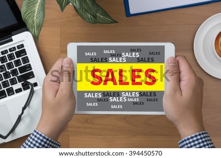 man hand Tablet with SALES MARKETING CONCECT and coffee cup