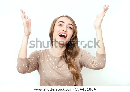 Screaming lady, emotions. Face with toothy smile. Woman in stylish clothes to make-up and hairstyle in studio isolated. Bright positive emotions of young woman and raised his hands up in prayer