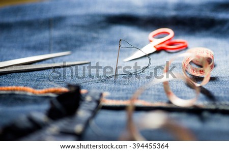 sewing machine, needle, scissors and sewing tools Royalty-Free Stock Photo #394455364