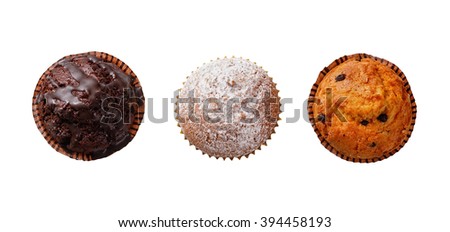 Three cupcakes on a white background .View from above. Royalty-Free Stock Photo #394458193