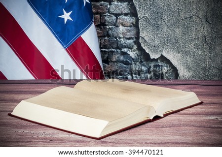Opened book on a background of the USA flag