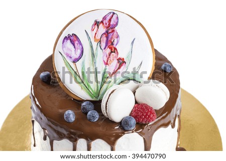 delicious cake with chocolate, gingerbread with a picture of tulips and fresh berries