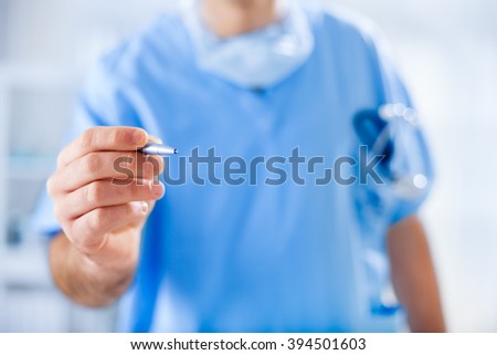 Young doctor is holding a pen