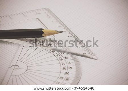 Close up of drawing equipment on graph paper