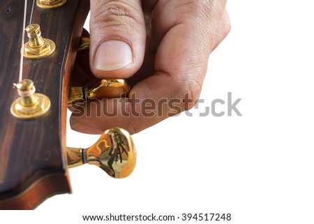 Man tuning guitar headstock on white background 