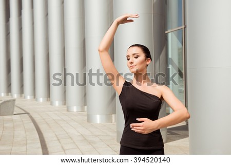 Close up portrait of elegant young ballerina dancing in the street