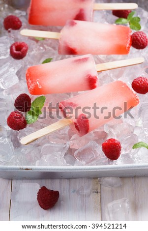 raspberry ice cream pop on ice tray with fresh red berry