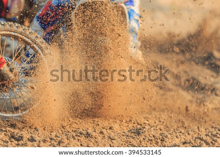 Motocross racer accelerating in dirt track, Details of debris in a motocross race and Picture blur
