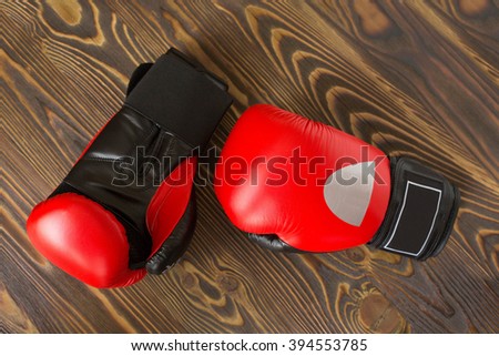red and black boxing gloves on the wooden background