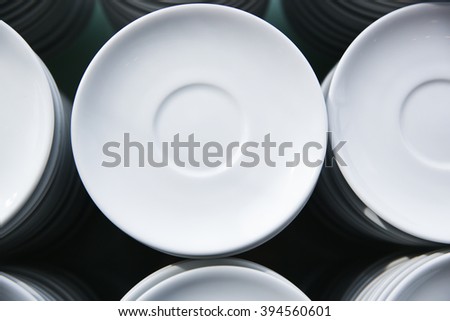 Stacks of white saucers