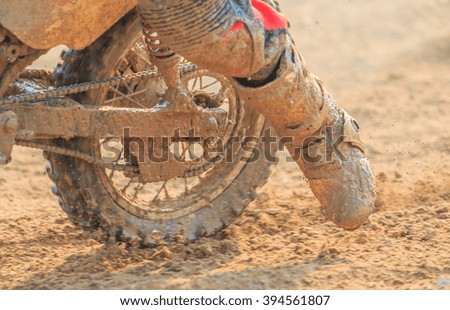Motocross racer accelerating in dirt track, Details of debris in a motocross race and Picture blur