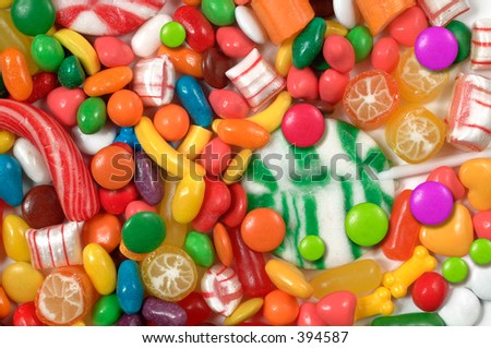 Assorted colorful candy and green lollipop