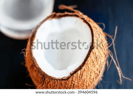 Close up of a coconut with milk  on a wooden background