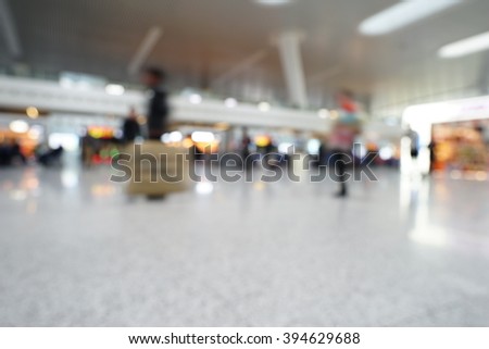 Blurred background : Traveler waiting at airport terminal or train station lobby blur background with bokeh light.