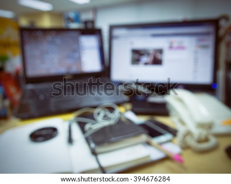 blur background of busy working desk,abstract office with computer blur background vintage style