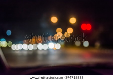 blur image of inside cars with bokeh lights from traffic jam on night time for background.