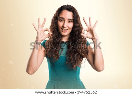 Teenager girl making OK sign