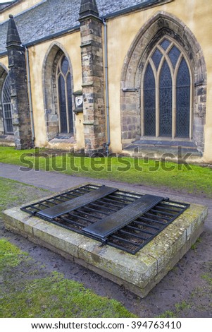 An iron cage (known as a mortsafe) covering a grave in Greyfriars Cemetery in Edinburgh, Scotland.  Mortsafes were used in the 19th century to prevent bodysnatchers from stealing corpes.