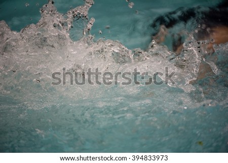 Water splash from young man swim in the pool for swimming competition