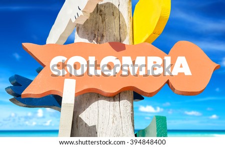 Colombia signpost with beach background
