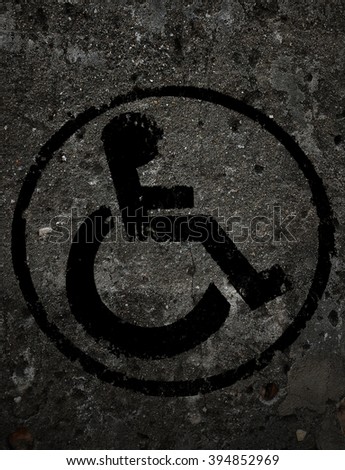 disabled icon sign, black old wall background.