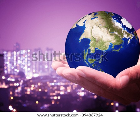 The world is on hold for the city bokeh blur background. earth social in human the hand. Businessman holding planet Earth in palm. Elements of this image furnished by NASA.