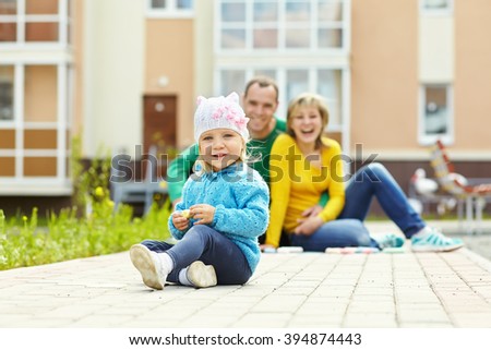 happy family outdoors. young parents with a baby for a walk in the summer. Mom, dad and child