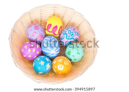 Easter eggs in the basket isolated on white background