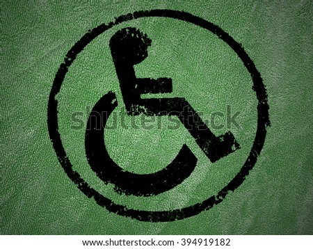 disabled icon sign, green old fabric background.