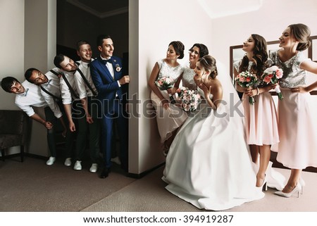 Groomsmen & Bridesmaids having fun & posing in hotel room Royalty-Free Stock Photo #394919287