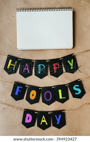 Happy april fools day banner lettering on craft paper background. Space for text, copy. Greeting postcard template.