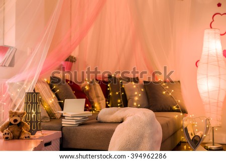 Fairy lights and baldachin in teen bedroom Royalty-Free Stock Photo #394962286