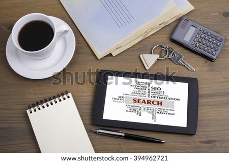 Search word cloud, business concept. Text on tablet device on a wooden table