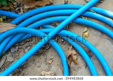 Rubber tube, Water hose have blue color place on the Brick worm in the garden