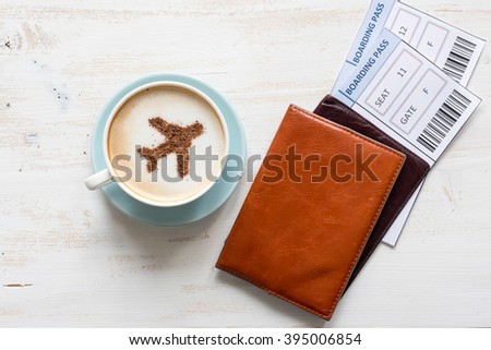 Cup of coffee, passports and no name boarding passes.
Airplane made of cinnamon in coffee. Traveling concept. Cappuccino in airport  Royalty-Free Stock Photo #395006854