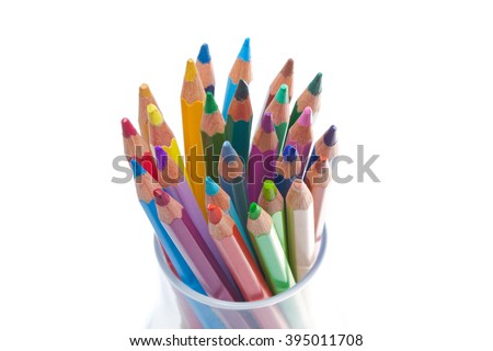 colored wooden pencils isolated on white background in a glass. Slightly twisted
