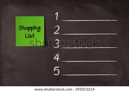 Green Shopping List sticky note pasted on blackboard.