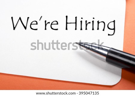 We are hiring. Office desk table with notepad, pen. Top view. 