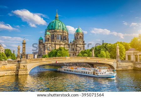 Beautiful view of historic Berlin Cathedral (Berliner Dom) at famous Museumsinsel (Museum Island) with excursion boat on Spree river in beautiful evening light at sunset in summer, Berlin, Germany Royalty-Free Stock Photo #395071564