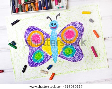closeup of a drawing: happy butterfly with colorful wings