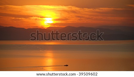 Sea sunset, boat on hyaline