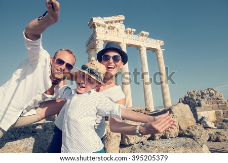 Positive young family take a sammer vacation selfie photo on antique sights view